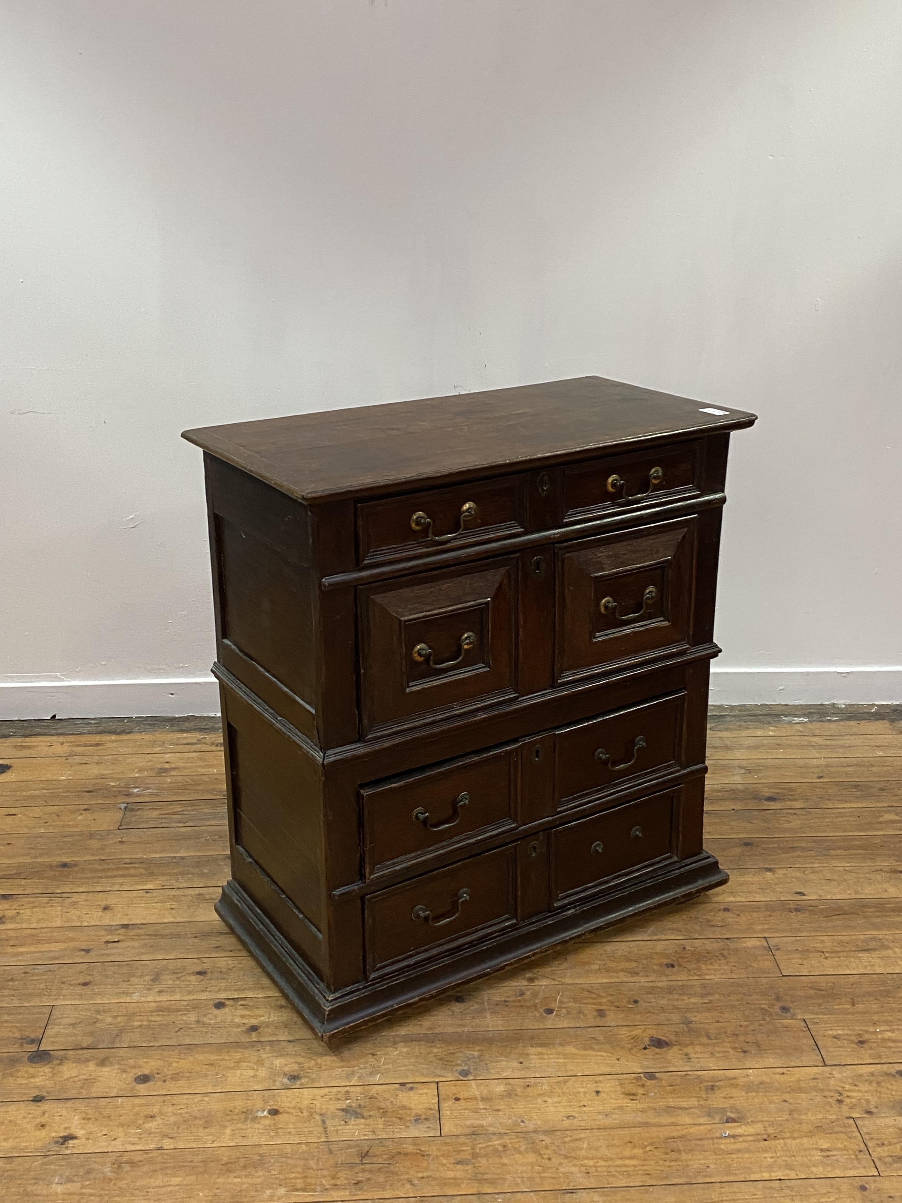 An oak chest of drawers, early 17th century and later, the top with moulded edge over four panel - Image 2 of 3