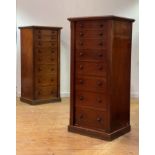 A pair of Victorian mahogany Wellington chests, each with eight graduated oak lined drawers on a