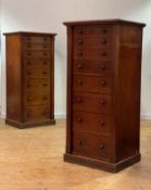 A pair of Victorian mahogany Wellington chests, each with eight graduated oak lined drawers on a