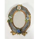 A Venetian glass-framed easel mirror, c. 1900, the bevelled oval plate within a frame applied with