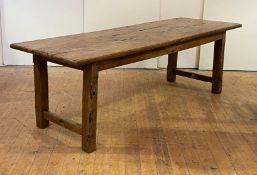 A large French vernacular fruitwood dining table, early 19th century, the scrub top raised on square