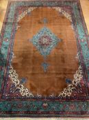 A large North West Persian carpet, hand knotted, the field of blues, browns and reds with