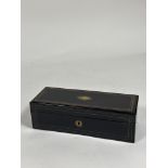 An early 19th century brass-inlaid ebony glove box, of plain oblong form, containing three pairs