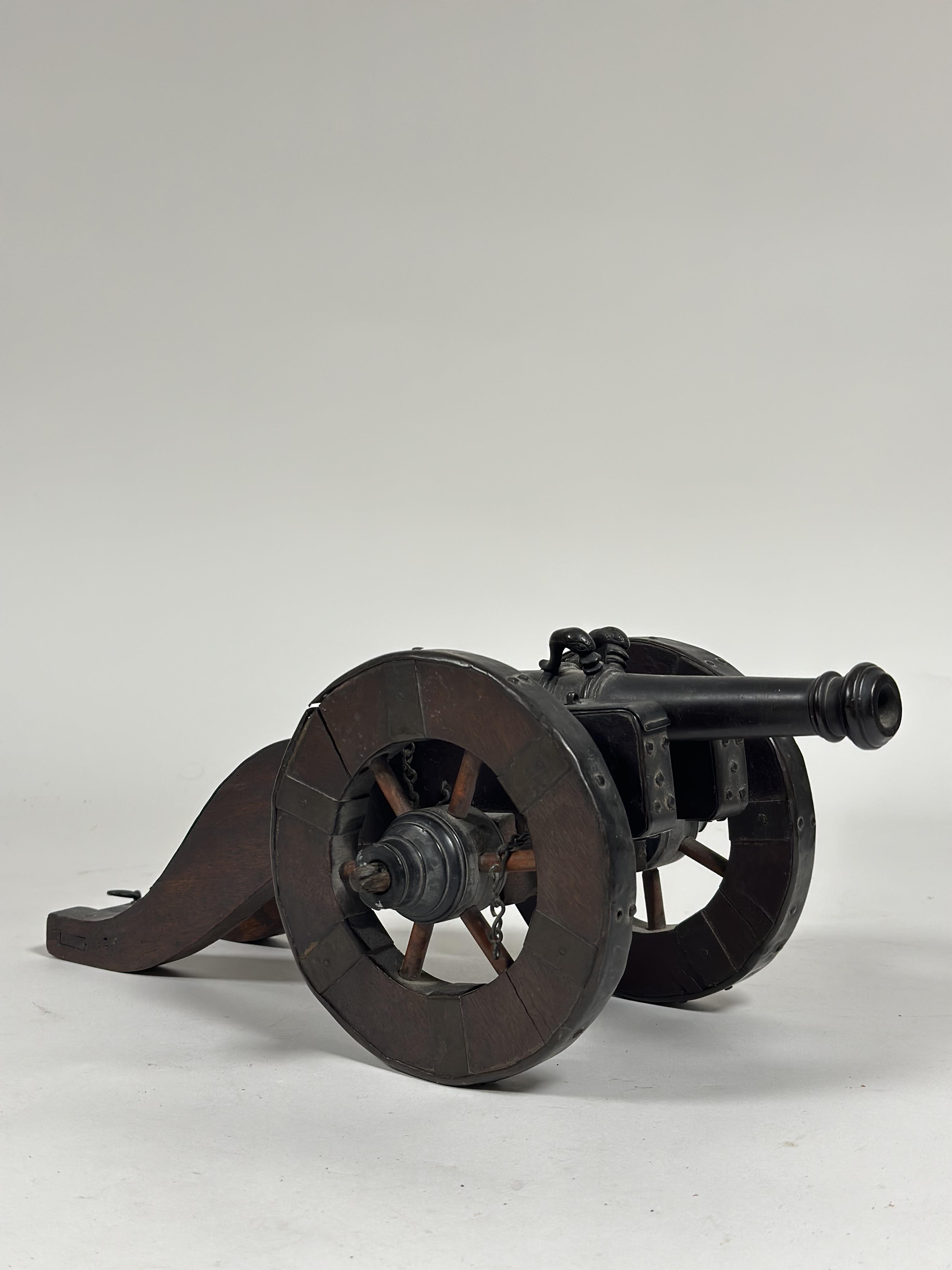 A model bronze cannon, in 17th century style, the barrel inscribed with a spurious date "Ao 1666",
