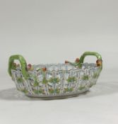 A Herend porcelain basket, oval, the latticework sides applied with foliate sprigs, the twin handles