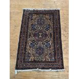 A Fine Persian hand knotted rug, the ivory ground decorated with triple medallion, stylised animal