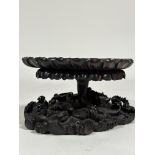 A striking 19th century Chinese hardwood vase stand, modelled as a lily pad emerging from