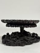 A striking 19th century Chinese hardwood vase stand, modelled as a lily pad emerging from