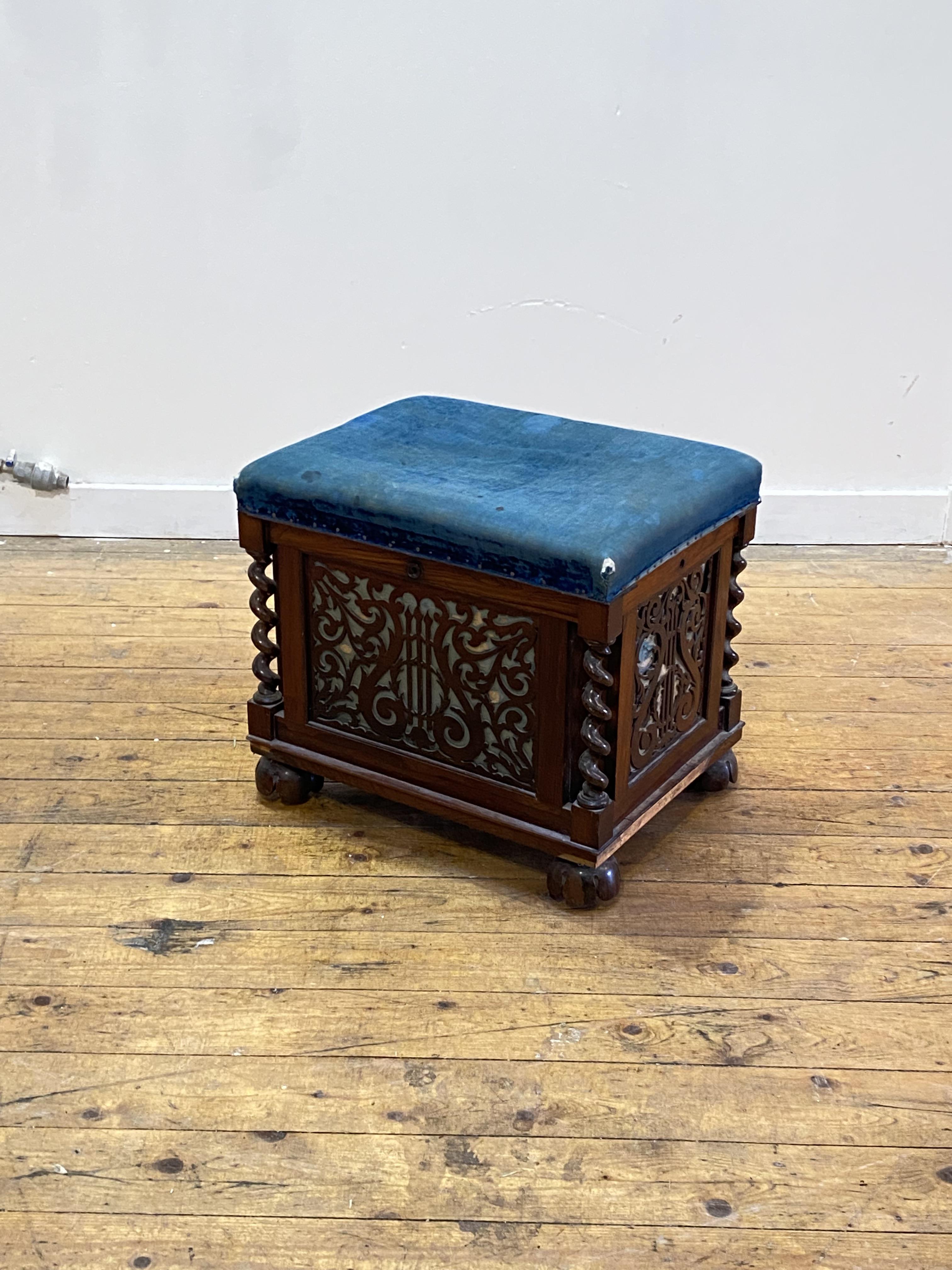 An early Victorian rosewood music stool, the worn blue velvet upholstered top lifting to an interior - Image 4 of 4