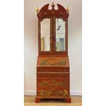 A George II style red lacquer and gilt Chinoiserie bureau bookcase, circa 1920-30, the broken arch