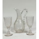 An etched glass wine ewer, of baluster shape with moulded ropetwist handle, densely etched with vine