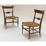 A pair of Victorian mahogany apprentice chairs, the bowed and shaped crest rail over shaped rail