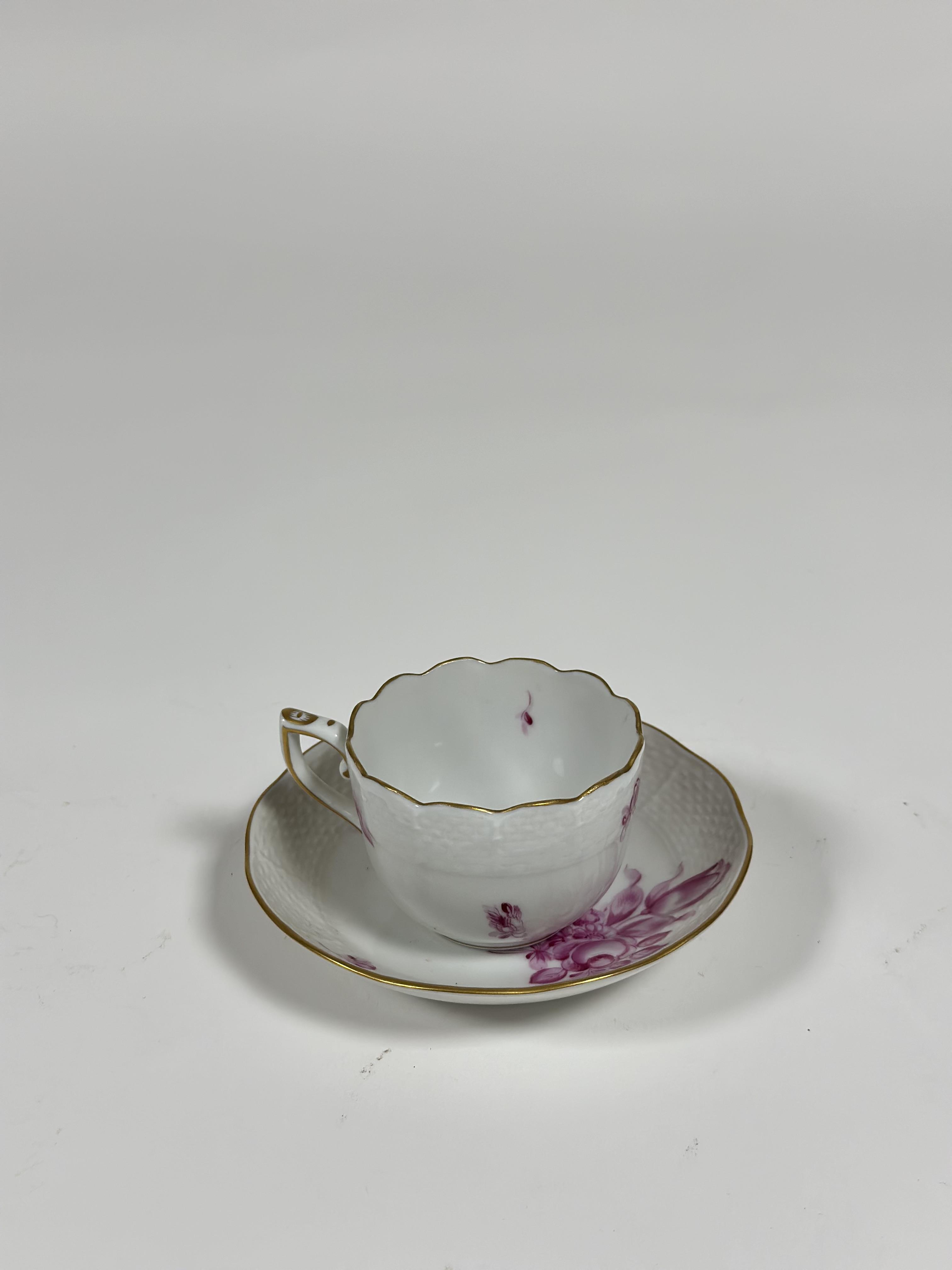 A Herend coffee cup and saucer in the puce tulip spray pattern, with ozier moulded borders,