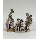 A group of 19th century Continental porcelain figures comprising: a Meissen figural candlestick (