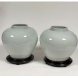 A pair of Chinese heavily potted monochrome glazed porcelain jars, in a clair de lune or bluish