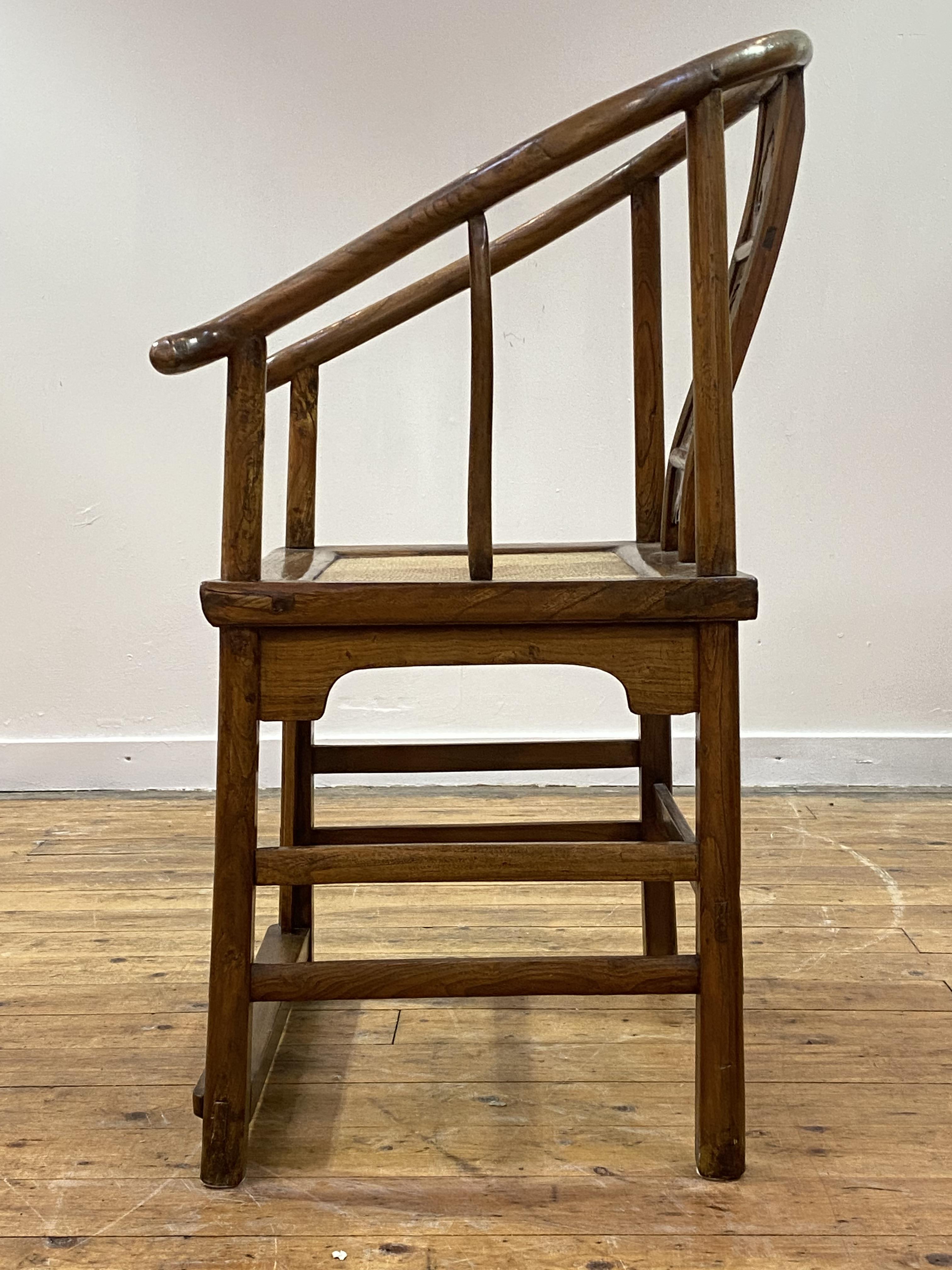 A Chinese elm horseshoe back chair, late 19th/ early 20th century, the sweeping crest rail with - Image 4 of 6