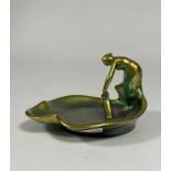Zsolnay Pecs: a leaf-shaped dish modelled with a figure with a water pitcher, in an eosin green/gold