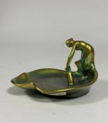 Zsolnay Pecs: a leaf-shaped dish modelled with a figure with a water pitcher, in an eosin green/gold