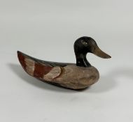 Folk Art: a painted wooden decoy duck, with red-tipped wings. Length 30.5cm