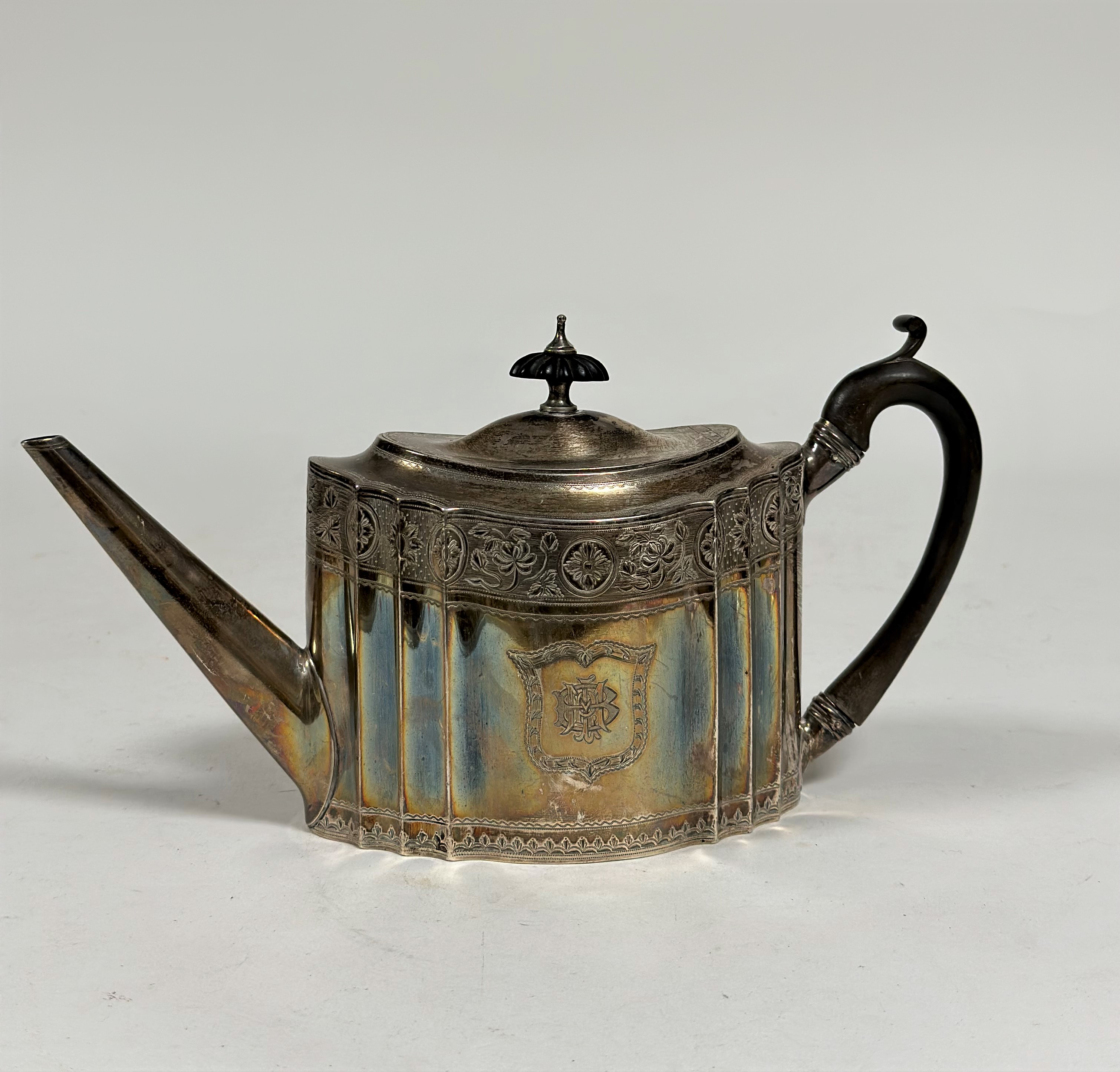 A George III silver teapot, Charles Aldridge, London 1793, oval, with bright-cut decoration, further