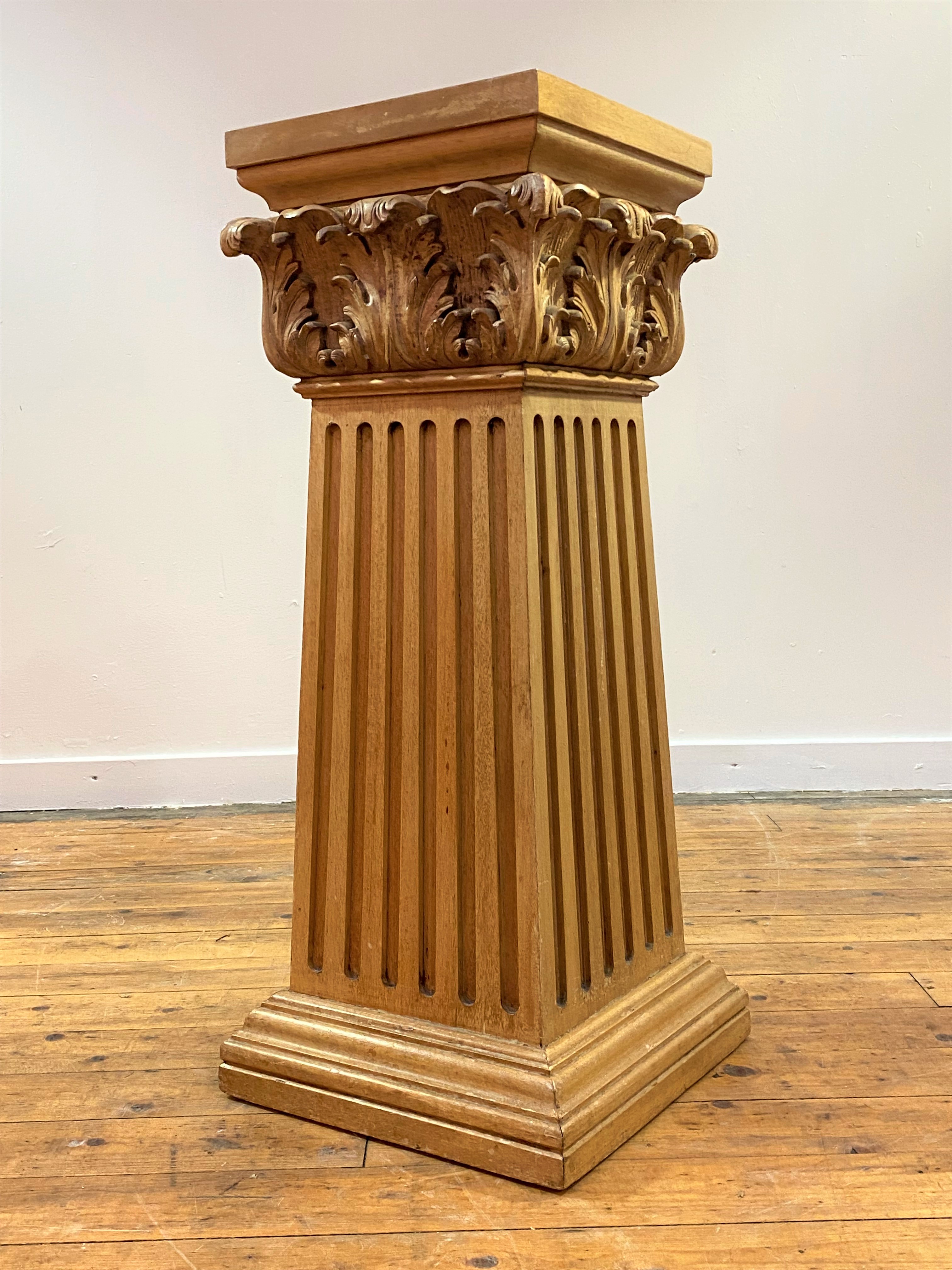 A carved beech plinth of Classical design, the square moulded and acanthus-carved capital over