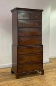 A George III mahogany tallboy of narrow proportions, early 19th century, the dentil cornice over two