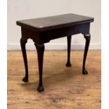 An Irish George III mahogany tea table, 18th century, the fold over top supported on a swing leg