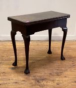An Irish George III mahogany tea table, 18th century, the fold over top supported on a swing leg