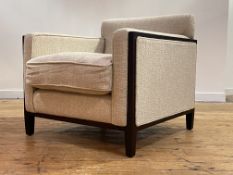 A contemporary designer lounge chair, upholstered in Larsen linen and standing on stained square