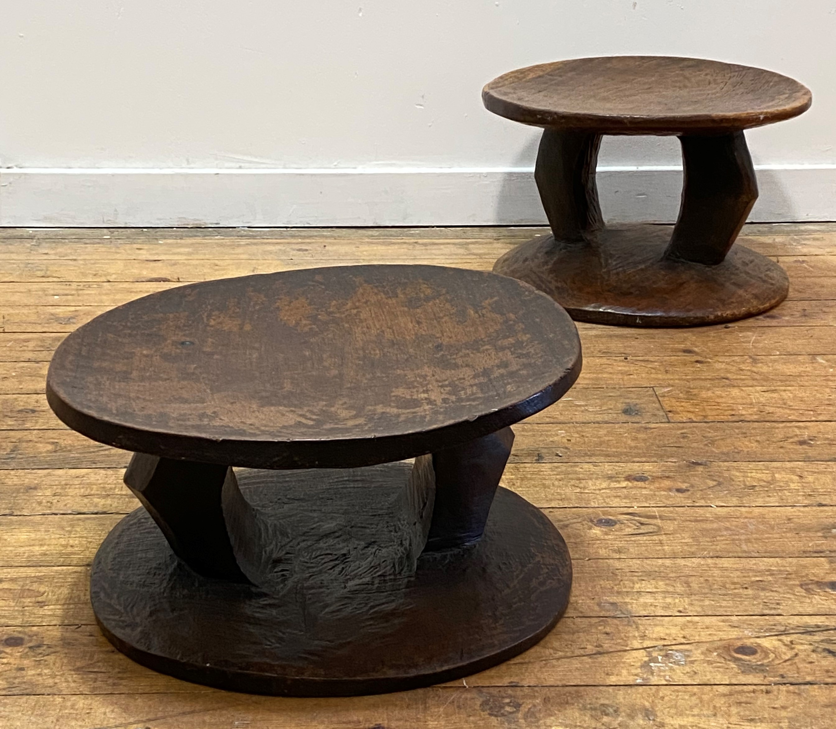 A pair of African tribal stools, circular dished seats raised on shaped pierced supports over a - Image 2 of 2