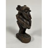 An African carved wooden female figure, possibly Songye. Height 25cm