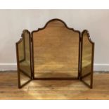 An 18th century style walnut framed triptych toilet mirror, circa 1920s, the top of undulating form.