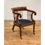 A Regency rosewood library chair, the shaped crest over swept arms with scrolled terms having