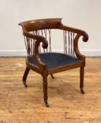 A Regency rosewood library chair, the shaped crest over swept arms with scrolled terms having