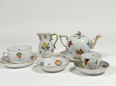 A Herend Vegetable pattern partial tea service comprising: teapot with floral knop; cream jug;