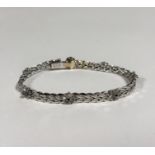 An Italian sapphire-set 18ct white gold bracelet by UnoAErre, of engraved fancy links, spaced by