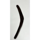 An Aboriginal boomerang, decorated with zoomorphic and other designs to one side, the reverse with