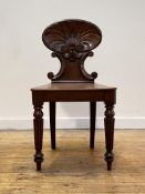 A William IV mahogany hall chair, the shell back of cartouche form carved with 'C' scrolls, over