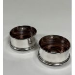 A pair of Elizabeth II silver bottle coasters, Mappin & Webb, London 2000, of plain circular form,