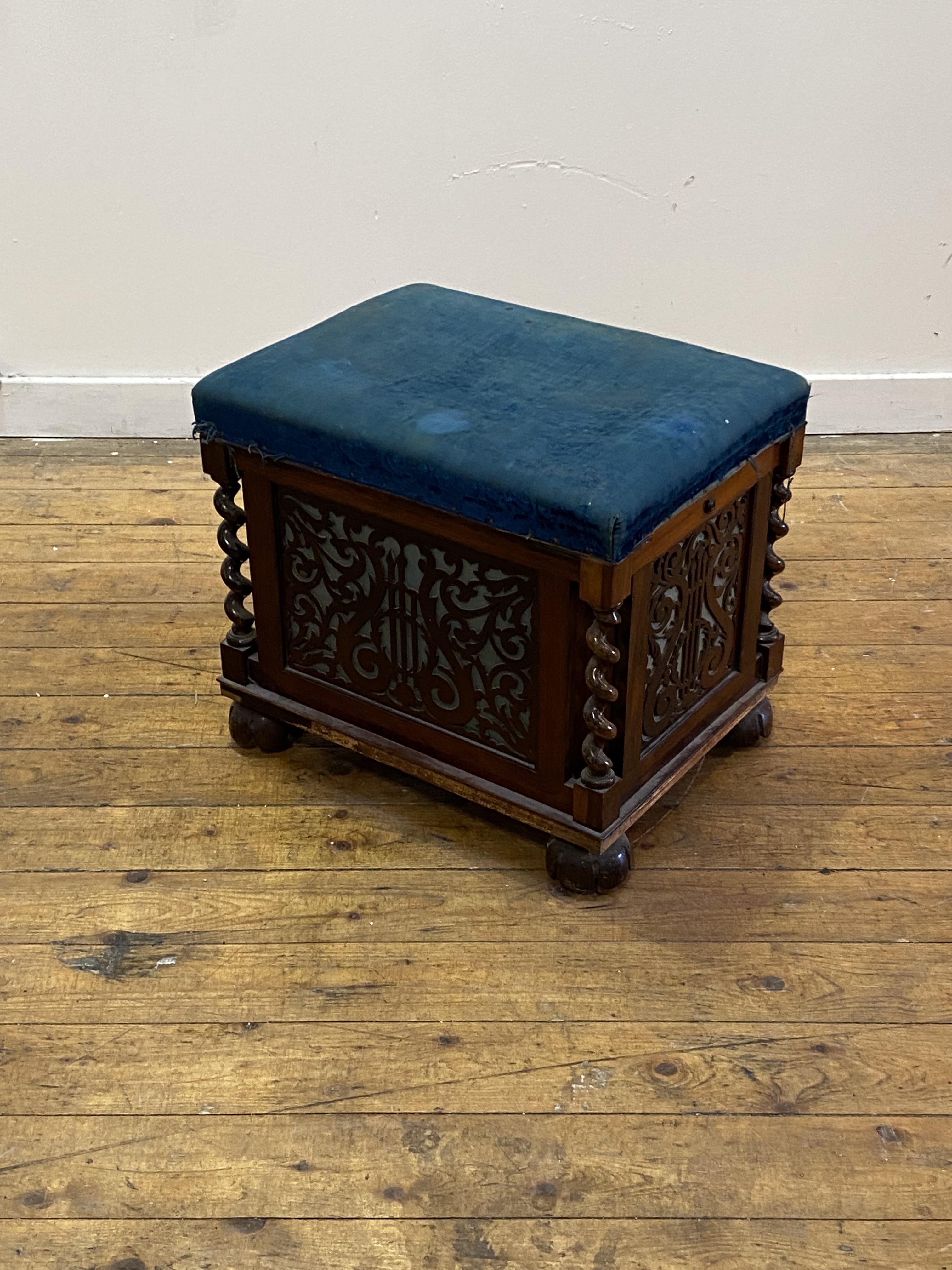 An early Victorian rosewood music stool, the worn blue velvet upholstered top lifting to an interior - Image 2 of 4