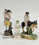 A group of early 19th century Staffordshire figures comprising: a pearlware figure emblematic of