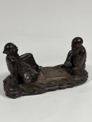A Chinese carved wooden group of two seated figures playing "Go", unsigned. Height 23cm, length