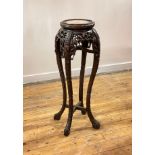 A Chinese hardwood jardiniere stand, early 20th century, the circular top inset with Breche Violette