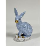 A large Herend porcelain model of a seated rabbit, in the blue fishnet pattern, with gilt snout
