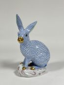 A large Herend porcelain model of a seated rabbit, in the blue fishnet pattern, with gilt snout