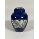 A Chinese porcelain jar and cover, painted with a pair of famille rose fan-shaped cartouches with