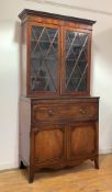 An early 19th century mahogany secretaire bookcase, the dentil cornice over a well figured frieze,