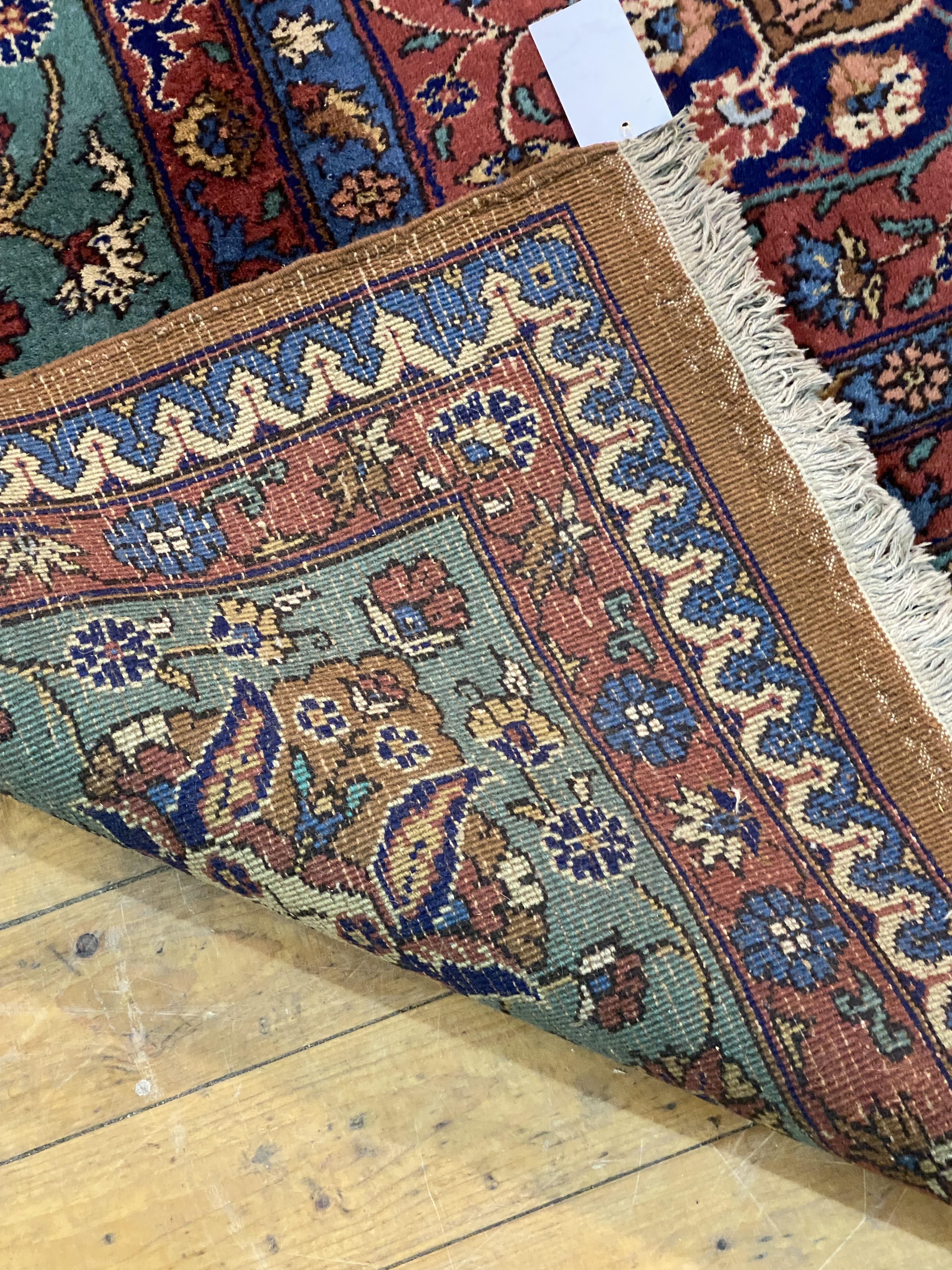 A large North West Persian carpet, hand knotted, the field of blues, browns and reds with - Image 3 of 3
