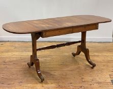 A Regency rosewood sofa table, the cross banded top with drop leaf to each end, over frieze having