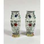 A pair of Chinese famille rose porcelain baluster vases, of faceted baluster form, with chilong